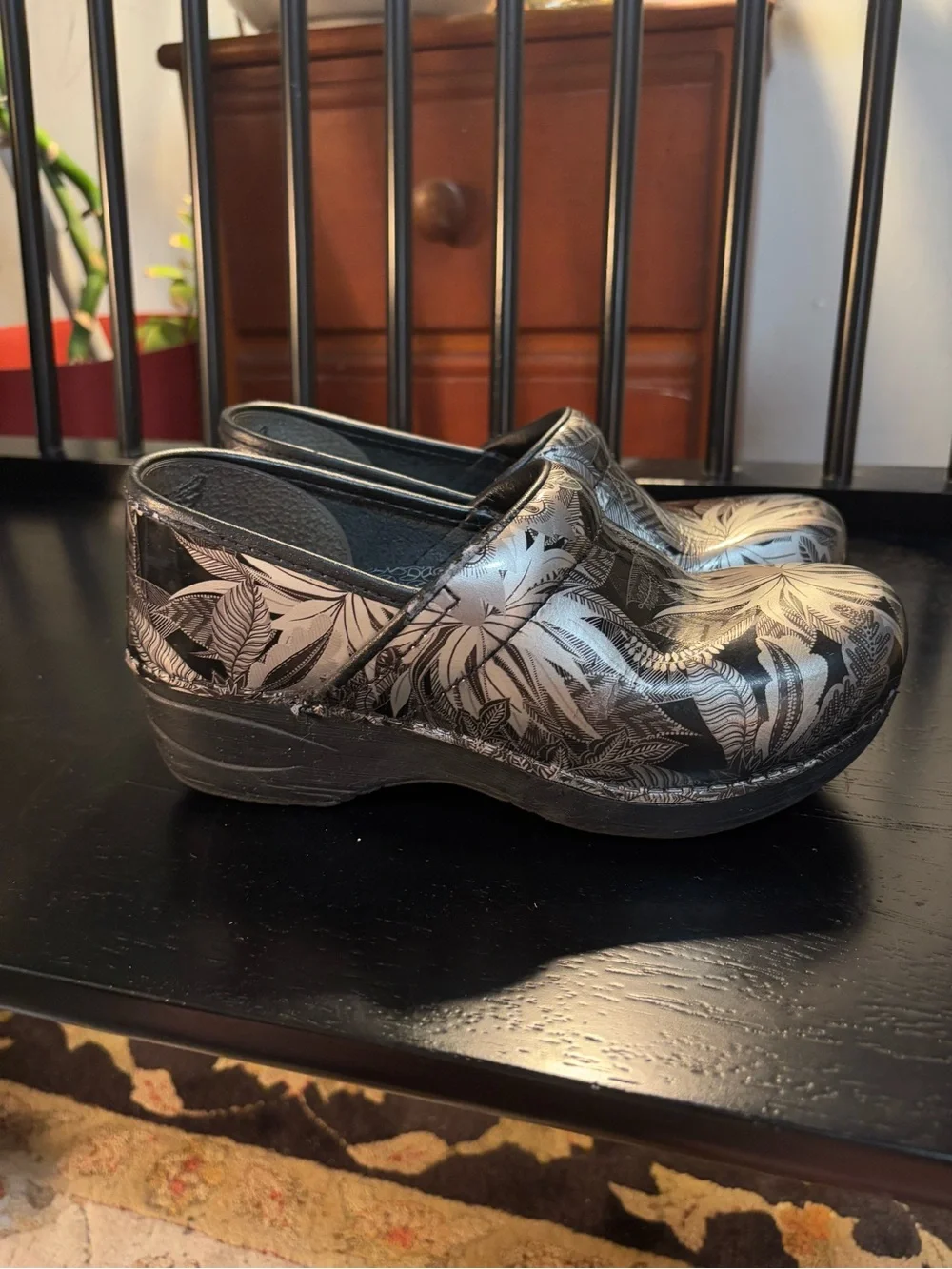 Dansko Black Clogs with Silver Floral Print